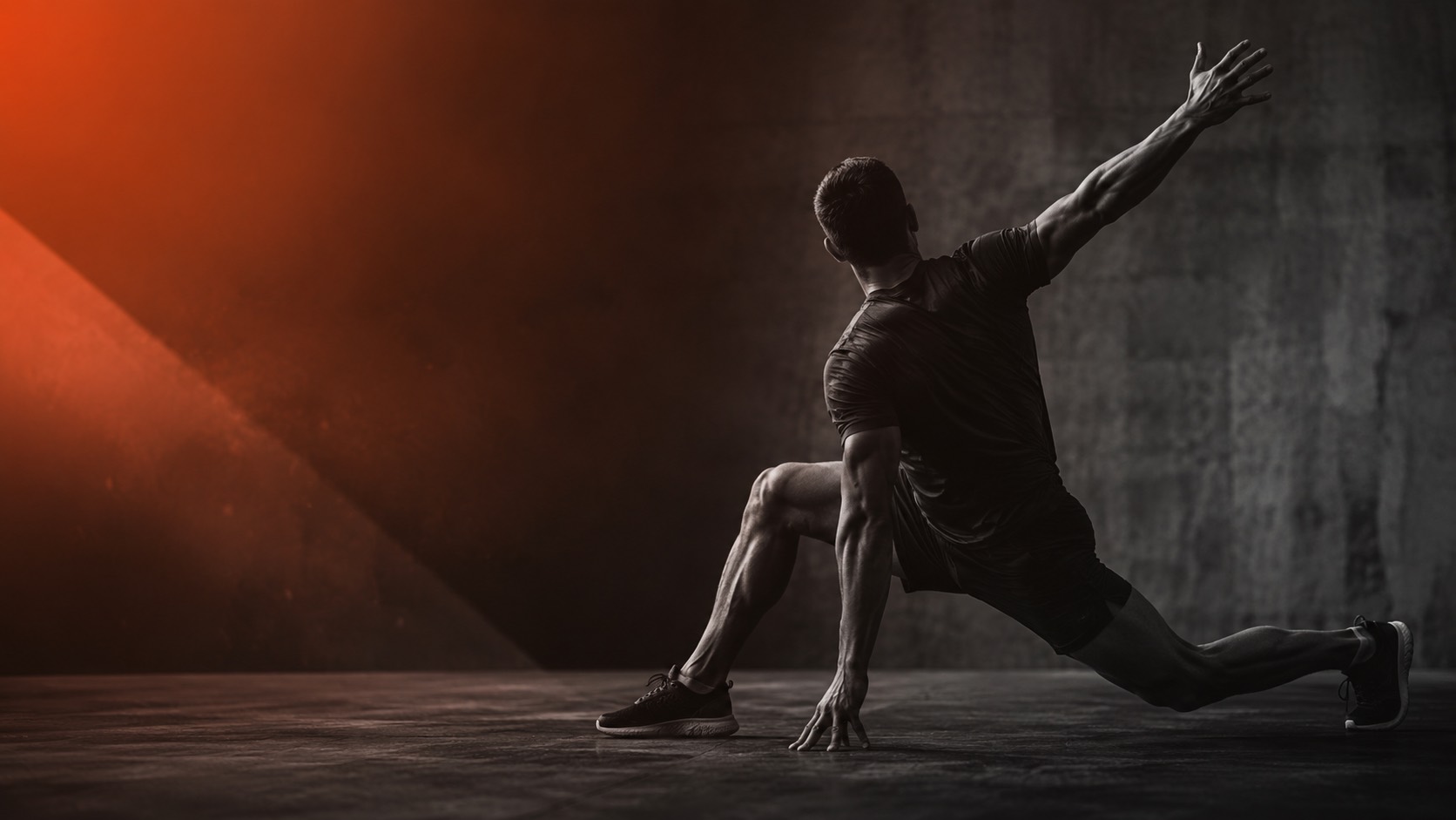 Athlete moving in a dramatic ember-lit studio
